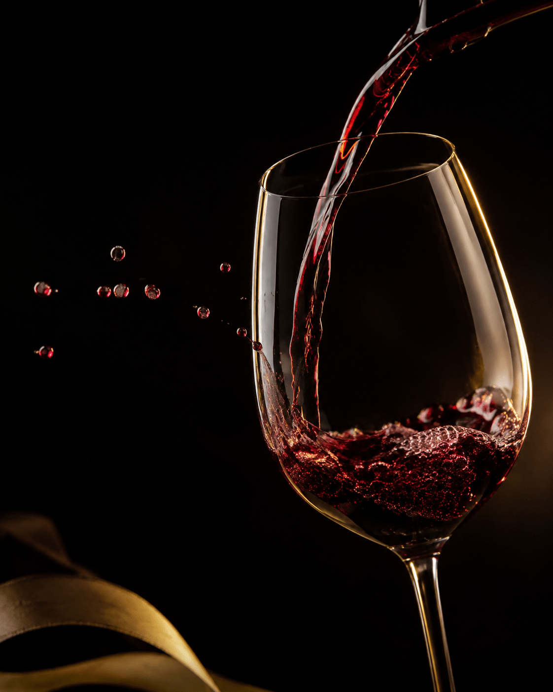 deep red Merlot being poured into a wine glass